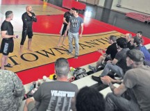 From left, mixed martial arts fighters Marcus “The Irish Hand Grenade” Davis, Frank Trigg, Cole “The Apache Kid” Escovedo and Tim Kennedy talk to members of the KMC about their backgrounds during the Armed Forces Entertainment 2014 MMA All-Stars Summer Tour June 19 on Kleber Kaserne.