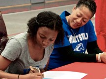 Courtesy photoAlana C. Dickerson, a senior and guard forward on the Kaiserslautern High School Lady Raider basketball team, signs a letter of intent Nov. 14 to attend the University of Alabama in Huntsville and play for coach Roy Heintz and the Lady Chargers. Dickerson, a 
three-year varsity player and returning captain, led the Lady Raiders to the 2013 
Department of Defense Dependents Schools-Europe Division 1 Basketball Championship, the first title for Kaiserslautern since 2008. She was selected as a 2013 DODDS All-
Europe performer and is a three-year all-academic athlete with a GPA of 3.7. Dickerson also received scholarship offers from Oglethorpe University in Atlanta and the University of Dallas. Dickerson and her teammates will attempt to win a second consecutive Division 1 championship as they open their season against Division 1 rival Wiesbaden Dec. 7 at Wiesbaden High School.