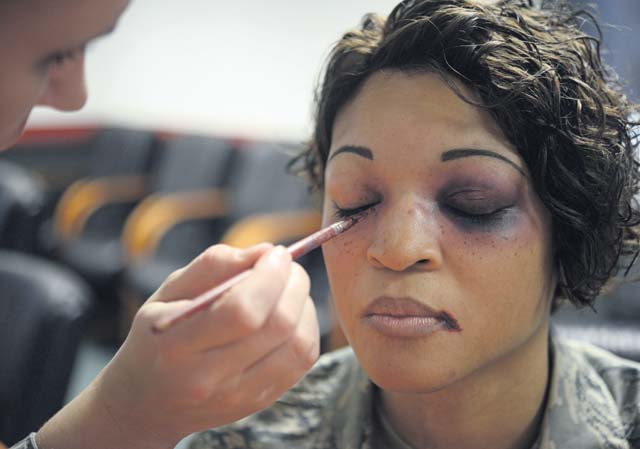 Photo by Senior Airman Timothy MooreSenior Airman Liberty Provo, 86th Dental Squadron dental laboratory technician, applies makeup to Tech. Sgt. Erica Carr, 86th Communications Squadron KMC frequency manager, to simulate domestic violence injuries Oct. 2 on Ramstein. October is Domestic Violence Awareness Month, and this year’s theme is “Thanks for Asking.” Participants volunteered to don the fake injuries to raise awareness for domestic violence victims who sometimes remain silent. 