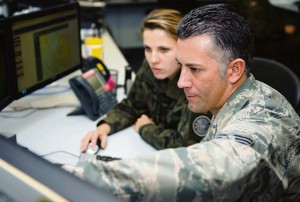 Staff Sgt. James Yonko, 21st Operational Weather Squadron regional forecaster supervisor, shows 2nd Lt. Monika Kaczanowska, Polish armed  forces meteorological and oceanographic officer, how to read and use weather predictions from the 21st OWS for Europe and Africa Nov. 14 on Kapaun Air Station. The 21st OWS hosted two Polish members from Nov. 9 to Saturday to build and learn from each other in order to operate better when deployed together.