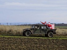 Photo by Senior Airman Armando A. Schwier-MoralesSanta rides in an Army Humvee after dropping from an Air Force C-130J Super Hercules to deliver toys Monday at the Alzey Drop Zone, Germany. The operation delivered toys donated by the KMC to less fortunate children.