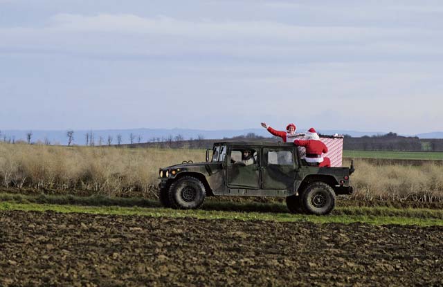 Photo by Senior Airman Armando A. Schwier-MoralesSanta rides in an Army Humvee after dropping from an Air Force C-130J Super Hercules to deliver toys Monday at the Alzey Drop Zone, Germany. The operation delivered toys donated by the KMC to less fortunate children. 