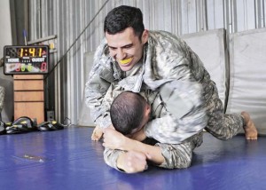 Spc. Daniel A. Lucero, strength management specialist with the 21st Special Troops Battalion, 21st Theater Sustainment Command, attempts to choke out his opponent during the combatives portion of the 21st STB Best Warrior Competition March 4 on Rhine Ordnance Barracks.