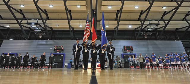 The 86th Force Support Squadron guardsmen post the colors Dec. 5. Navy and Armed Forces Entertainment hosted a Harlem Globetrotters basketball game in support of the troops at the Ramstein Southside Fitness Center.