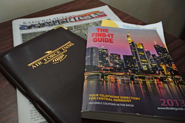 The base newspaper, guest directory and a local information guide are left on the desk of a  hotel room to ensure guests have what they might need.