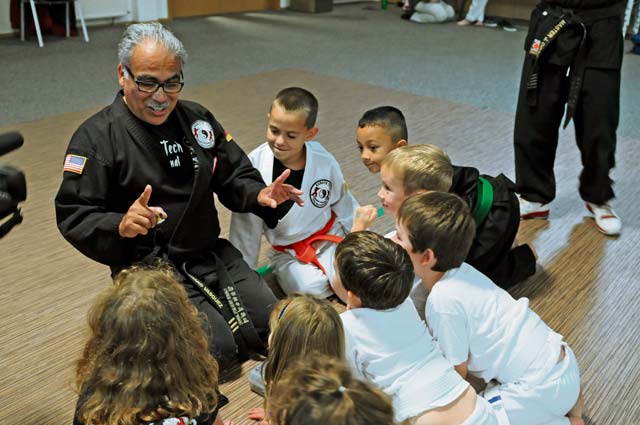 Karate Tech class instructor Richard Vasquez quizzes students to evaluate their knowledge of martial arts Oct. 8 on Vogelweh. The Karate Tech class is offered to KMC members of all ages to learn self-defense. The instructor trains students not only to compete in martial arts competitions, but to strengthen the body and soul. Using techniques created more than 1,400 years ago, students learn to improve self- discipline and to defend themselves if needed. Class instructors provide instructions on using a variety of techniques from several martial art disciplines. Classes are held at the Vogelweh and Ramstein community centers for students with all levels of karate experience.