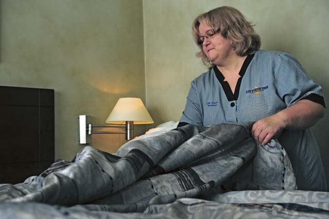 Air Force Inns housekeeper Ute Spang makes the bed in a hotel room Sept. 25 on Ramstein.