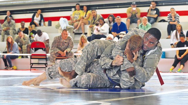 Pfc. Justin Jordan attempts a headlock during a combatives tournament Sept. 15 at the Kleber Fitness Center.