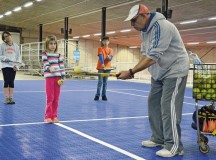 Adel Ismail offers indoor tennis instruction at the Rhine Ordnance Barracks special events center as part of SKIESUnlimited, a Child, Youth & School Services program at U.S. Army Garrison Rheinland-Pfalz.
