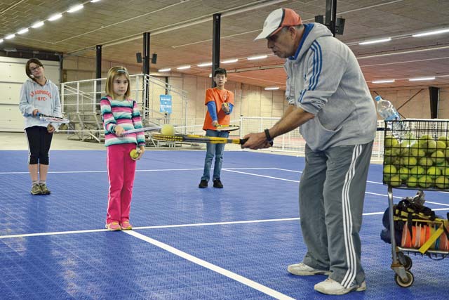 Adel Ismail offers indoor tennis instruction at the Rhine Ordnance Barracks special events center as part of SKIESUnlimited, a Child, Youth & School Services program at U.S. Army Garrison Rheinland-Pfalz.