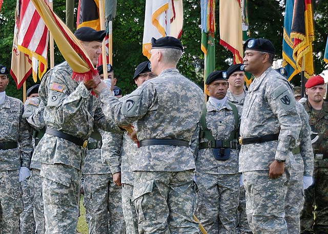 Lt. Gen. Donald M. Campbell Jr., commanding general of U.S. Army Europe, passes the colors of the 21st Theater Sustainment Command to Maj. Gen. John R. O’Connor, the new commanding general of the 21st TSC, during a change of command ceremony June 28 at Daenner Kaserne.
