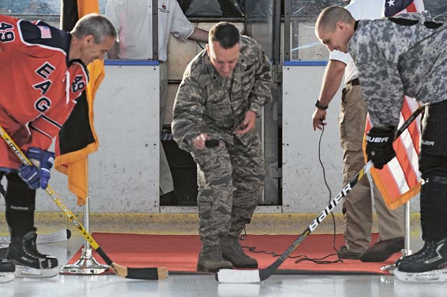 Photo by Senior Airman Hailey HauxBrig. Gen. Patrick X. Mordente, 86th Airlift Wing commander, drops the puck during the first hockey game of the Cuddeback Cup hockey tournament Sept. 27 in Zweibrücken, Germany. The tournament honored Airman 1st Class Zachary Cuddeback, a fallen Airman from the 86th Vehicle Readiness Squadron and former KMC Eagles hockey team member.