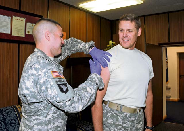 Photo by Staff Sgt. Warren W. Wright Jr.Maj. Gen. John R. O’Connor, the 21st Theater Sustainment Command commanding general, receives his seasonal flu shot from Sgt. Nathaniel Dozeman, NCOIC of the Kleber Medical Clinic Soldier Medical Readiness Center, Wednesday on Panzer Kaserne. The CG urges all Team 21 members to stay “Ready-Strong” with regular vaccinations. Army health officials established an immunization schedule to ensure all Soldiers and family  members have the opportunity to fight the flu. To see the schedules, see Page 8 or visit the Kaiserslautern American online at www.kaiserslauternamerican.com. For more information, call 1st Lt. Adam Eschenlauer at 483-7475.