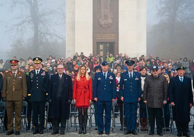 Attendees of a Veterans Day ceremony stand during the posting of the Colors Nov. 11 in Luxembourg.