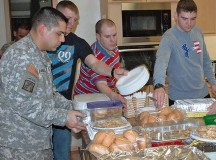 Photo by Sgt. Jere R. CerdenioSoldiers from the 21st Theater Sustainment Command’s 95th Military Police Battalion, 18th Military Police Brigade prepare food Jan. 16 to be served at the Fisher House on Wilson Barracks. The Fisher House Foundation is a nonprofit organization that provides comfort homes for military and veterans’ families while a loved one is receiving treatment.