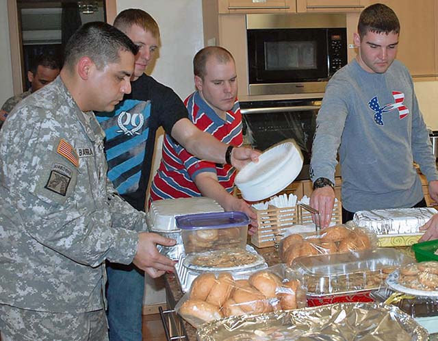 Photo by Sgt. Jere R. CerdenioSoldiers from the 21st Theater Sustainment Command’s 95th Military Police Battalion, 18th Military Police Brigade prepare food Jan. 16 to be served at the Fisher House on Wilson Barracks. The Fisher House Foundation is a nonprofit organization that provides comfort homes for military and veterans’ families while a loved one is receiving treatment.