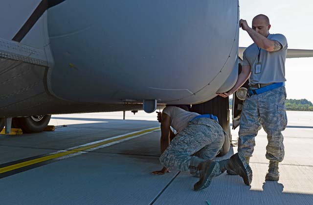 Tech. Sgt. Edwin Huertas, 86th Aircraft Maintenance Squadron population engineer NCOIC, and Senior Airman Ridge Rozier, 86th AMXS hydraulics specialist, take a cover off a C-130J Super Hercules June 7 on Ramstein. Members of the 86th AMXS work round the clock to ensure aircraft are mission ready at all times.