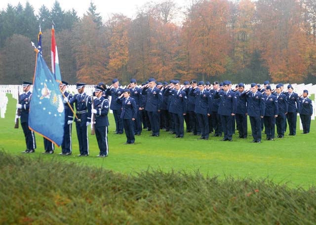 Airmen from the 52nd Fighter Wing and 726th Air Mobility Squadron out of Spangdahlem Air Base render a salute during the playing of taps at a Veterans Day ceremony Nov. 11 at the Luxembourg American Cemetery and Memorial.  Maj. Gen. John R. O’Connor, commanding general of the 21st Theater Sustainment Command, along with senior leaders from the 52nd Fighter Wing, participated in the ceremony to honor U.S. service members both past and present.