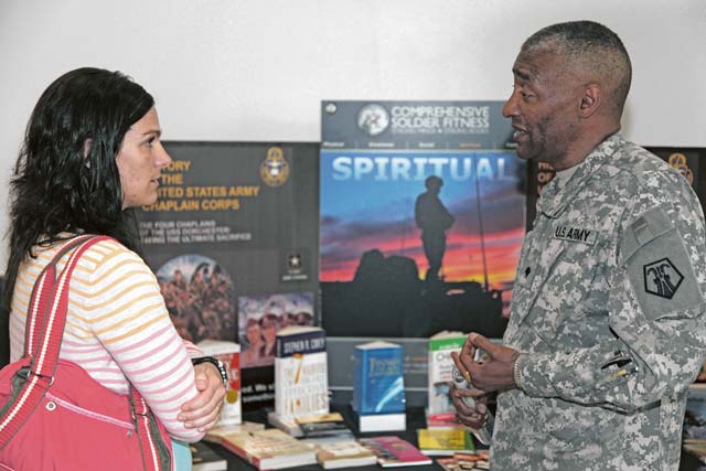 Amanda Reuter (left) speaks with Spc. Miguel Ramos, chaplain’s assistant with the 7th Civil Support Command, about the possibility of becoming a chaplain’s assistant in the Army when the 7th CSC hosted the U.S. Army Reserve birthday celebration April 23 at the Kaiserslautern Military Community Center food court.
