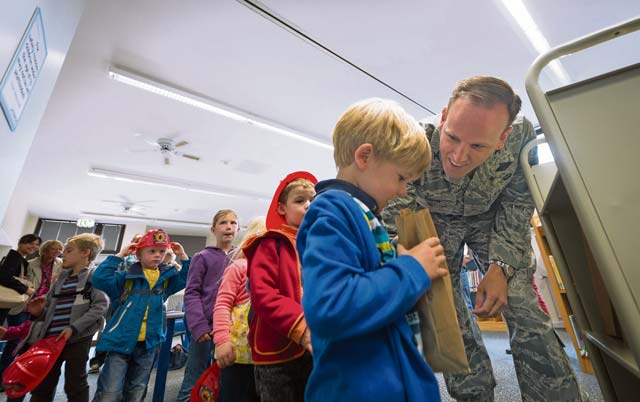 Col. Lee Smith, 86th Airlift Wing vice commander, hands out goodie bags to a group of children from the Villa Winzig Kindergarten.