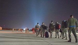 Nearly 30 Airmen walk down the flightline Oct. 15 after arriving on Ramstein from West Africa. Any personnel traveling into Ramstein from Ebola-infected areas will be medically screened upon their arrival and cleared by public health.