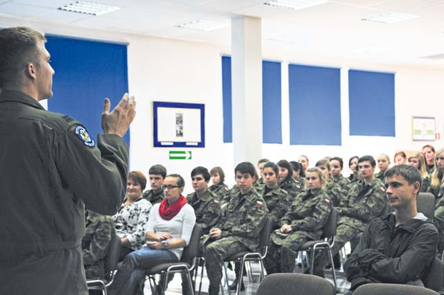 Capt. Brett Polage, 37th Airlift Squadron pilot, briefs students from the local high school in Poland about flying and life as a pilot in the U.S. Air Force  during a theater security cooperation event Oct. 22 at Powidz Air Transport Base, Poland. The students from the high school are the equivalent to the U.S. Air Force’s Junior Reserve Officers’ Training Corps.