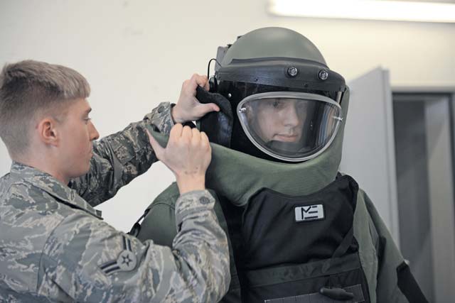 Photo by Staff Sgt. Kristopher LevasseurAirman 1st Class Jeffrey Knelange, 786th Civil Engineer Squadron Explosive Ordnance Disposal apprentice, helps Airman 1st Class Tyler Hatfield, 786th CES EOD apprentice, into his bomb suit before practicing unexploded ordnance operations. Ramstein EOD Airmen provide support to the base and the local community by helping destroy ordnance found in and around the local community. 