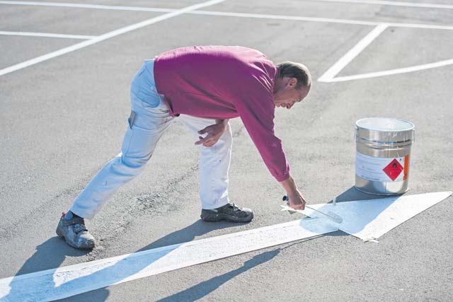 Photo by Senior Airman Damon KasbergAlfred Hasemann, 786th Civil Engineer Squadron painter, puts a fresh coat of paint over a worn out directional arrow. Airmen from the 786th CES maintain more than 1,700 facilities and more than 5,000 housing units on Ramstein, Sembach, Einsiedlerhof, Kapaun, Landstuhl, Vogelweh and 20 geographically separated units.