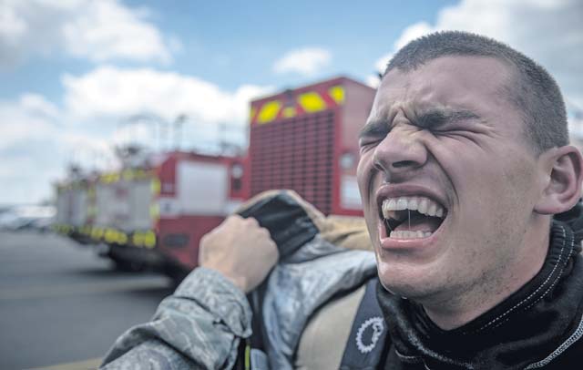 Photo by Airman 1st Class Jordan CastelanAirman Alexander Garratt, 86th Civil Engineer Squadron firefighter, cries out in exhaustion. Competitors had to put on full protective fire gear, sprint to the top of a two-story tower and pull a fire hose weighing 45 pounds through the window, then sprint down to the bottom floor, hit a 165-pound steel beam with a nine-pound hammer until it moved forward five feet, negotiate through a 100-foot serpentine course, drag a hose 75 feet and knock down a target with a stream of water. To end the course, firefighters had to drag a 175-pound dummy 100 feet to the finish line. 