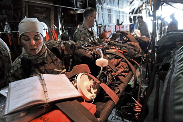 Master Sgt. Jennifer Higgs, 455th Expeditionary Aeromedical Evacuation Squadron technician, conducts an equipment  function check inside a C-130 Hercules Feb. 21, 2013, on Bagram Airfield, Afghanistan. The 455th EAES performs its missions on fixed wing aircraft, including the C-17 Globemaster III, C-130 Hercules and KC-135 Stratotanker, and can provide extensive critical care capability with the Critical Care Air Transport Teams.