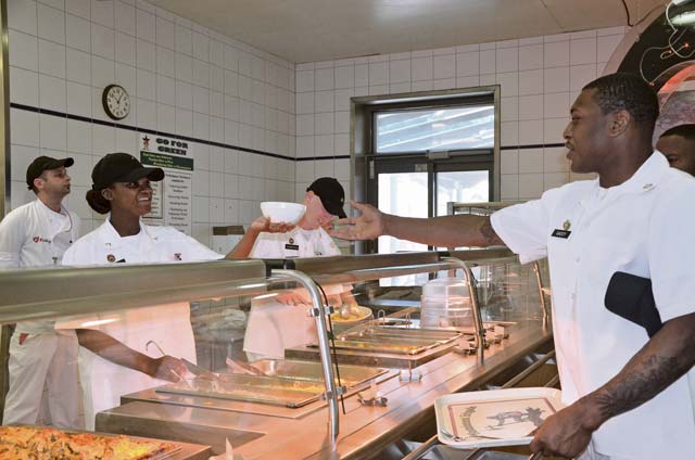 Photo by Elizabeth BehringPvt. Kirsten Hazel, culinary food specialist, hands a bowl of spaghetti to Pfc. Terrance Gaddy, also a culinary food specialist, during lunch at the Hard Rock Diner dining facility on Smith Barracks in Baumholder. The Hard Rock Diner recently won runner-up at the Department of the Army-level Phillip A. Connelly Awards and Best in Europe for fiscal year 2014. 