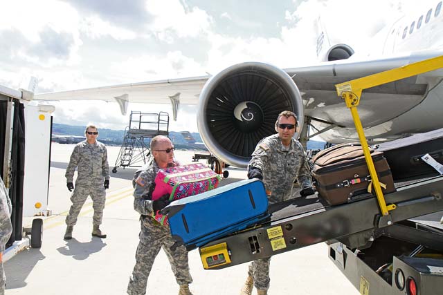 Staff Sgt. Thomas Christensen (center), from Salt Lake City, and Spc. Morgan Johnson (right), transportation management coordinators with the 7th Civil Support Command’s 1177th Movement Control Team, Kaiserslautern, Germany, are observed by a 721th Aerial Port Squadron Airman as they unload an aircraft as part of pre- deployment training and validation in air operations July 30 on Ramstein. 