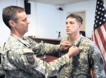 Col. Harrold J. McCracken (left), the U.S. Army Europe judge advocate, presents the Army Commendation Medal to Sgt. Blair E. Berry, a paralegal NCO with the 21st Theater Sustainment Command’s Office of the Staff Judge Advocate Legal Services Center.