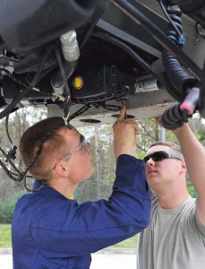 Airman 1st Class Ryan Haney (right) and Airman 1st Class Richard Lowry, 86th Vehicle Readiness Squadron vehicle maintainers, work together to fix an aircraft de-icer April 23 on Ramstein.