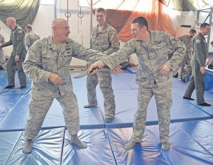 Staff Sgt. Josh Krape (center), 86th Operations Support Squadron survival, evasion, resistance and escape specialist, instructs Airmen on how to disarm a threat during a SERE refresher course.