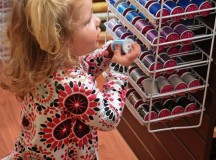 Georgia Tintle, 2, checks out the thread selection at the Kaiserslautern Arts and Cultural Center shop.