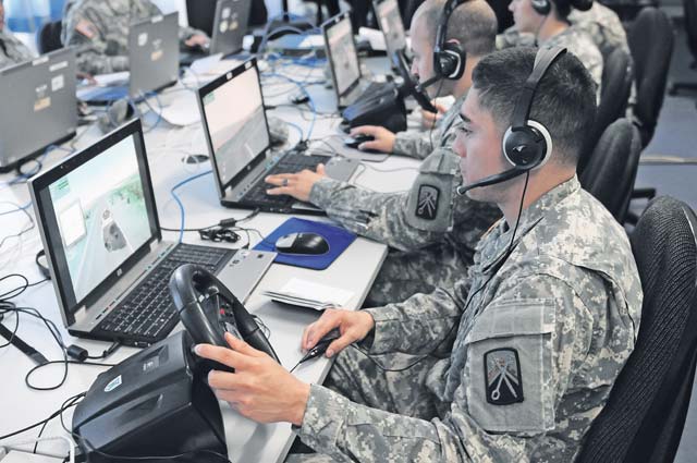 Photo by Brandon Beach Fernando Gomez, a customer service representative with Bravo Detachment, 106th Finance Management Support Unit and a native of Houston, Texas, operates a Humvee across a virtual battlespace using a steering wheel, brake and gas pedal during a training exercise on Panzer Kaserne July 17. Similar training took place simultaneously with other 106th FMSU detachments at Grafenwoehr, Germany and Vicenza, Italy. The entire exercise was set up by the 7th Army’s Joint Multinational Simulations Center and coordinated by Headquarters, 106th FMSU out of Baumholder.