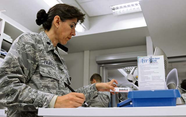 Lt. Col. Christine Fairley, 86th Medical Support Squadron diagnostic and therapeutic flight commander, prepares medicine for a KMC resident  getting medication through the Self-Initiated Care Kit program Sept. 13 on Ramstein. The objective of the S.I.C.K. program is to honor families’ time and resources by reducing appointments for over-the-counter medications.