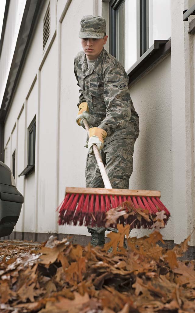Photo by Senior Airman Jonathan StefankoAirman John Crover, 86th Civil Engineer Squadron operations manager, gathers leaves during a base clean up Monday on Ramstein. The first of the two clean-up days directed the KMC to tidy up the interiors and exteriors of base facilities. The second day was focused on base housing areas. During the base clean up, KMC personnel picked up trash around their surrounding areas and gathered leaves and debris.