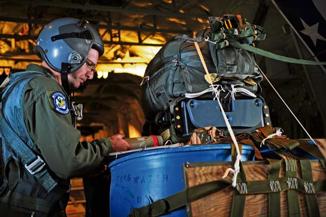 Master Sgt. Jason Beebe, 37th Airlift Squadron loadmaster, prepares the Joint Precision Airdrop System bundle for the first test employment during a joint training mission in Europe Oct. 23 at Powidz Air Transport Base, Poland. The JPADS is equipped with a GPS, allowing the bundles to land within feet of the point of impact, ensuring they get to war fighters.