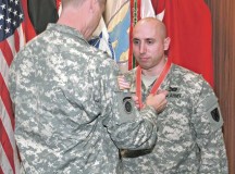 Sgt. 1st Class Justin Puls, a career counselor with the 21st Theater Sustainment Command, receives the Sgt. Morales Club medallion from Maj. Gen. John R. O’Connor, commanding general of the 21st TSC, during a ceremony on Dec. 4 on Panzer Kaserne in Kaiserslautern. Puls was inducted into the Sgt. Morales Club for embodying exceptional leadership characterized by personal concern for the needs, training, development and welfare of Soldiers.