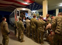 Members of the Contingency Aeromedical Staging Facility and 455th Expeditionary Aeromedical Evacuation Squadron help patients onto a medical bus bound for the flightline on Bagram Airfield, Afghanistan, March 21, 2013. The CASF is the relay between the Craig Joint Theater Hospital and aeromedical evacuation missions throughout Afghanistan.