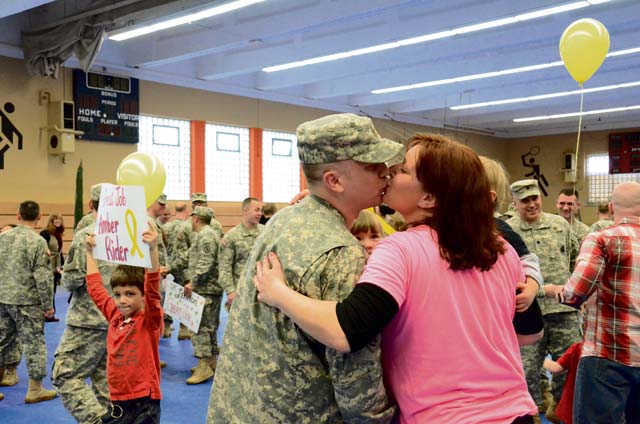 Photo by Ignacio RubalcavaA Soldier and his spouse reunite on Valentine’s Day. Soldiers from the 30th Medical Brigade, 421st Multifunctional Medical Battalion returned to Baumholder Feb. 14 after a nine month deployment to Kosovo. The Baumholder community turned out to welcome them back in a ceremony at the Hall of Champions on Smith Barracks.