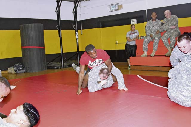 Retired Ultimate Fighting Championship fighter Din Thomas trains with Soldiers from the  18th Military Police Brigade Feb. 21 at the Sembach Fitness Center.