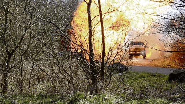 Photo by Ignacio “Iggy” RubalcavaA German tactical vehicle pushes through a fireball during a training  exercise March 27 on Baumholder’s military training area.