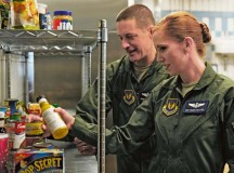 Senior Master Sgt. Mike Pelletier and Master Sgt. Amanda Pelletier, 76th Airlift Squadron flight attendants, sort through ingredients in the kitchen where meals are prepared before missions April 29.