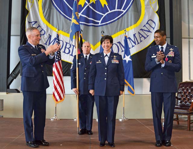 Photo by 2nd Lt. Henry LancasterCol. Nancy Bozzer, 521st Air Mobility Operations Wing commander, is recognized by  Maj. Gen. Frederick “Rick” Martin (left), U.S. Air Force Expeditionary Center commander,  Col. Randall Reed (right) and members of the wing during the 521st AMOW change of command June 18 on Ramstein.