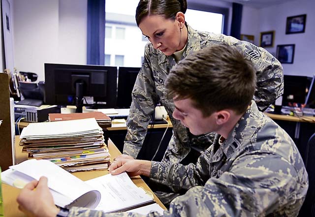 Staff Sgt. Katie McMahon (left), 700th Contracting Squadron contracting officer, and 1st Lt. Matthew Bogan, 700th CONS contracting officer, review a contract Dec. 16 on Kapaun Air Station. McMahon and Bogan work with other contracting officers to ensure Airmen have the resources necessary to complete any mission.