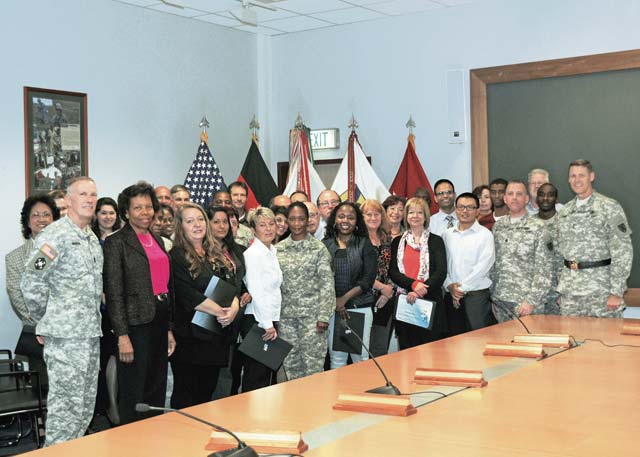 Photo by Staff Sgt. Warren W. Wright Jr.Budget specialists from throughout the 21st Theater Sustainment Command gather after receiving a commanding general’s certificate of appreciation from Maj. Gen. John R. O’Connor, commanding general of the 21st TSC, and Command Sgt. Maj. James J. Murrin, acting command sergeant major of the 21st TSC, during a ceremony Oct. 10 on Panzer Kaserne in Kaiserslautern. More than 40 people were recognized for their exceptional service in ensuring the fiscal year 2013 budget was closed out with 100 percent accuracy and with all funds accounted for.  