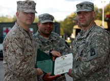 Lt. Col. Pete Faerber (left) and Maj. Jesse Delgado (center) present 
Staff Sgt. Tim Mika with the Air Medal Oct. 30 at the Landstuhl Army Heliport.